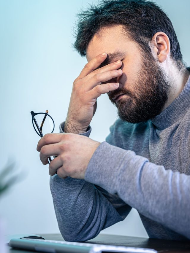 a man bothered by eye problems